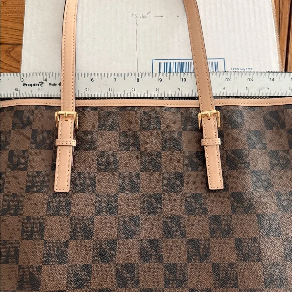 MICHAEL Michael Kors Jet Set travel tote in a brown checkered monogram pattern.